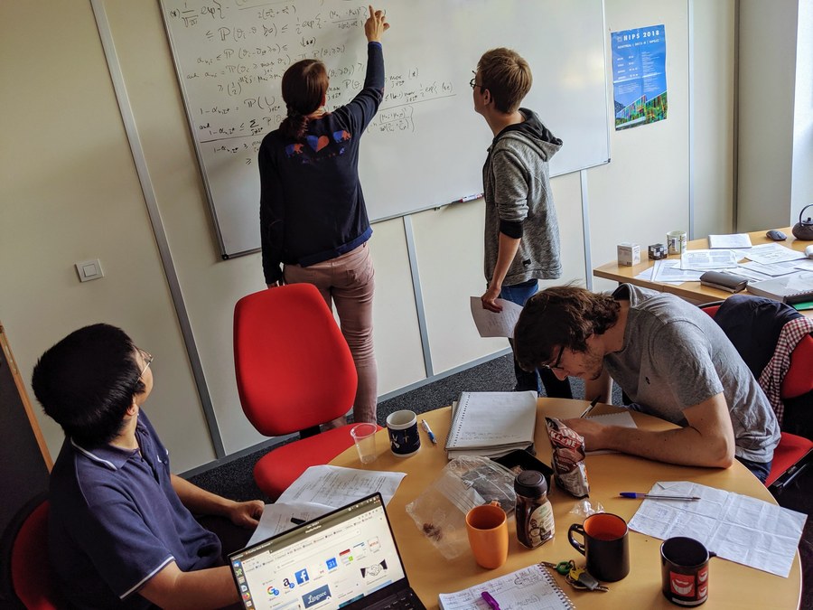 Researchers working together at a whiteboard